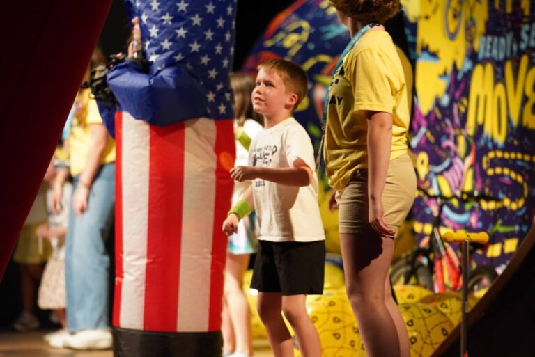 VBS actors and children on stage dancing